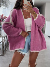 Load image into Gallery viewer, Person wearing a pink cardigan with white trim in an indoor setting